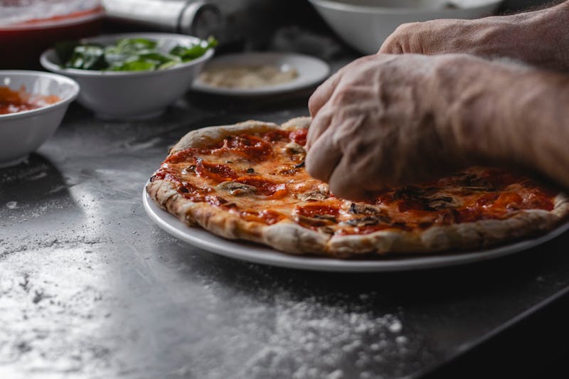 Dions team member preparing dion's pizza in Albuquerque